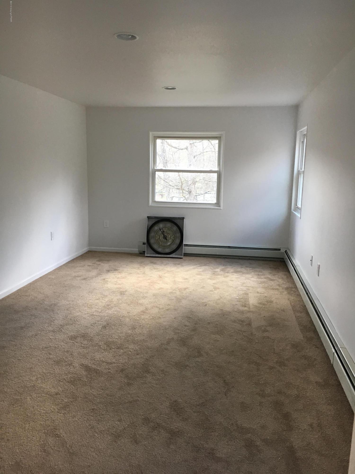6229 Decker Road Bushkill, PA 18324 - Photo 6 of 15 an empty room with a empty space and windows