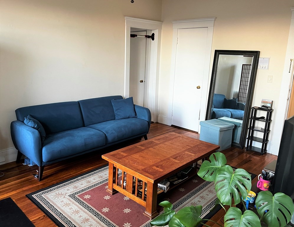 116 Sutherland Road, Unit 11 Boston, MA 02135 - Photo 3 of 6 a living room with furniture and a rug