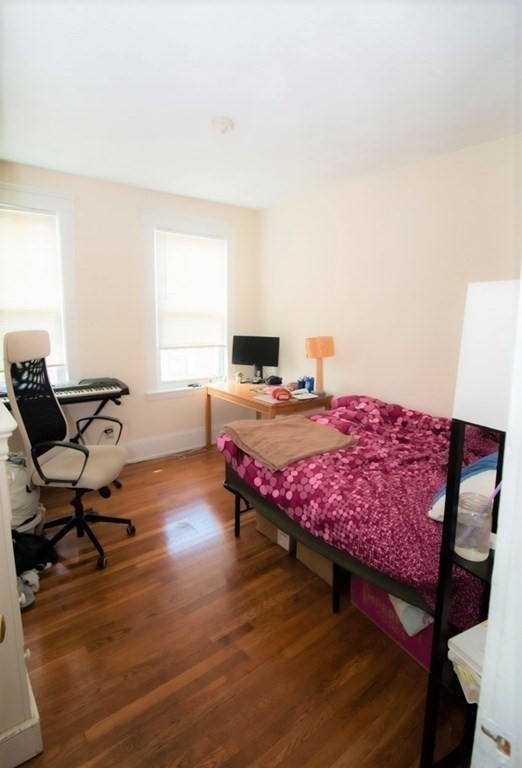 116 Sutherland Road, Unit 11 Boston, MA 02135 - Photo 4 of 6 a bedroom with a bed a table and chair