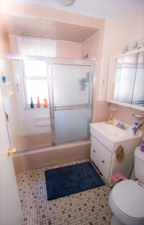 116 Sutherland Road, Unit 11 Boston, MA 02135 - Photo 5 of 6 a bathroom with a sink a toilet and shower