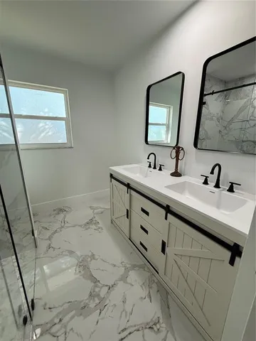 a bathroom with double sink and mirror