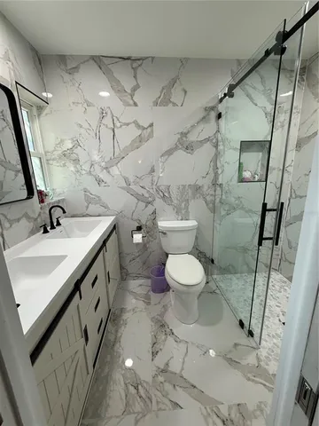 a bathroom with a sink toilet and shower