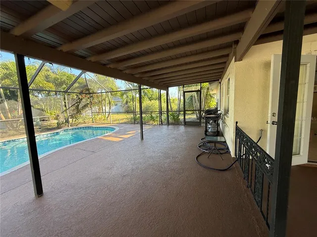 a view of a room with gym equipment and floor to ceiling window