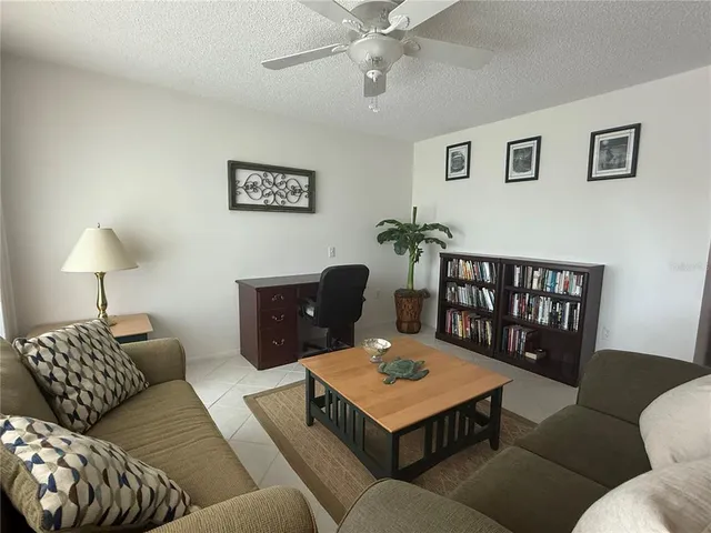 a living room with furniture a rug and a lamp