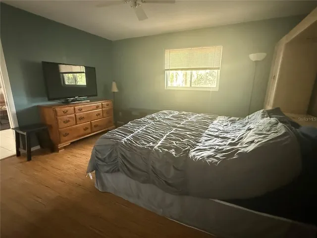 a bed sitting in a bedroom next to a window