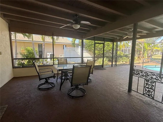 a view of a porch with chairs and backyard