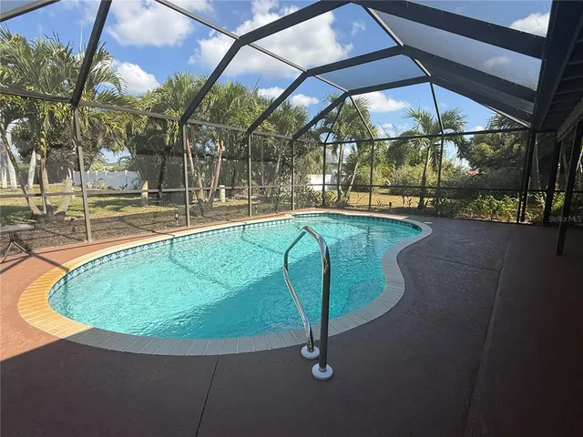 a view of a swimming pool with a yard in front of it