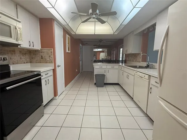a kitchen with stainless steel appliances a sink stove and cabinets