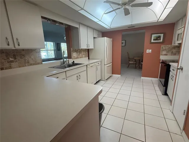 a kitchen with stainless steel appliances a refrigerator sink and cabinets