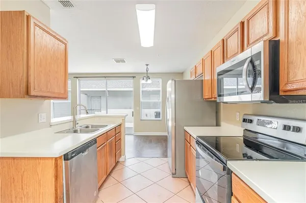 a kitchen that has a sink and a stove