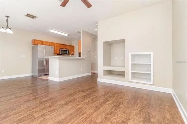 a view of a kitchen with wooden floor and a sink