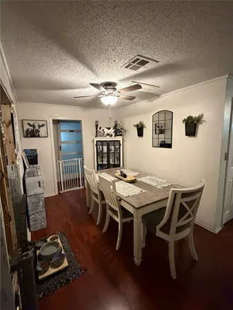 a view of a dining room with furniture and a chandelier