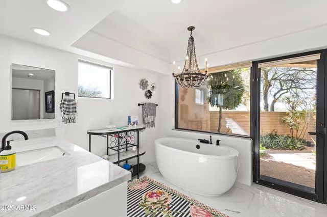 a bedroom with furniture and large windows