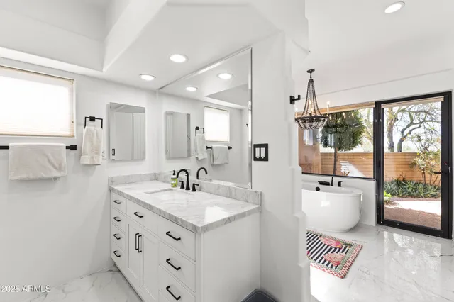 a white bath tub sitting next to a bathroom sink