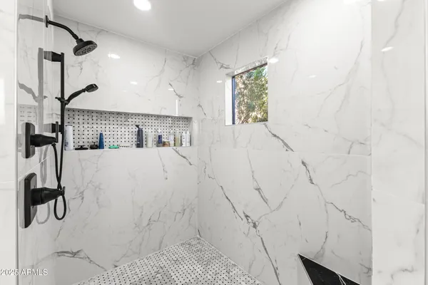 a spacious bathroom with a double vanity sink a mirror and a shower