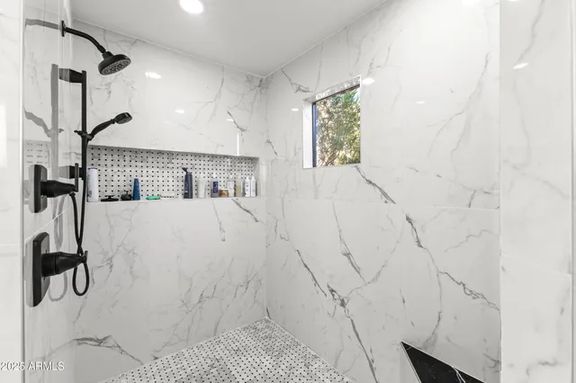 a spacious bathroom with a double vanity sink a mirror and a shower