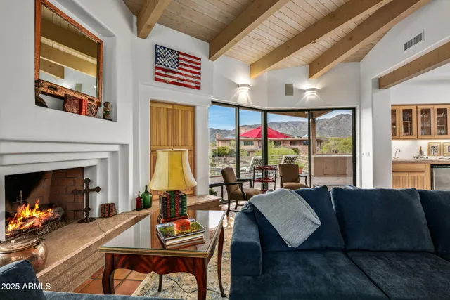 a living room with furniture and a floor to ceiling window