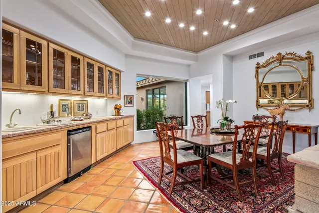 a living room with fireplace furniture and a large window