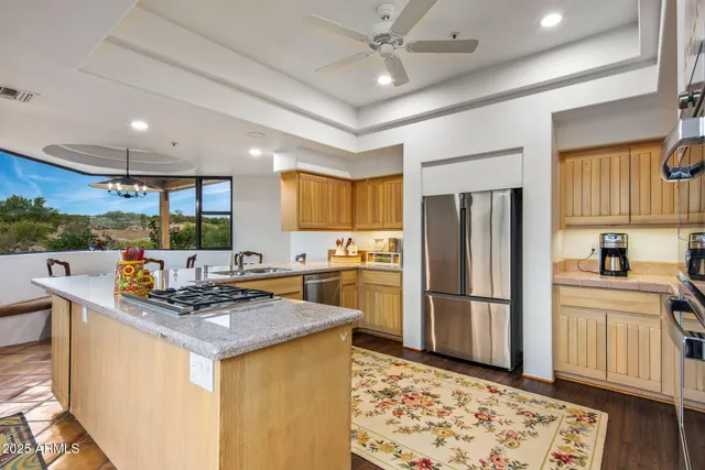 a dining hall with stainless steel appliances a dining table and chairs