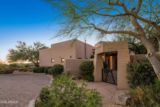a living room with furniture and a book shelf