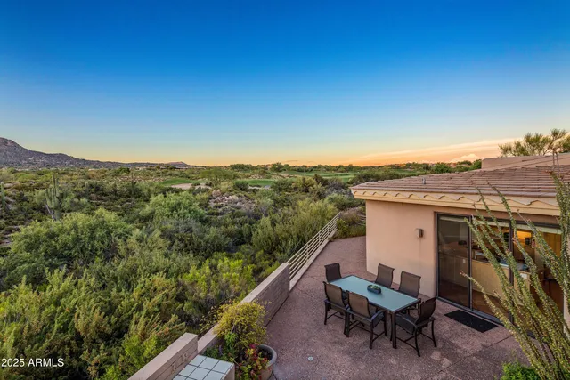 a view of a patio with a table chairs and a backyard