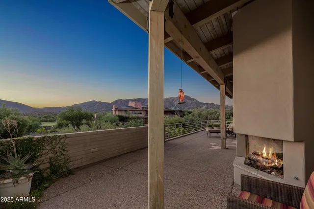 a view of a chairs and table in a balcony