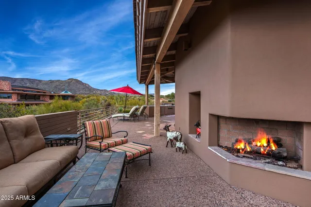 a outdoor living space with furniture and a fireplace