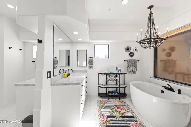 a bathroom with a bathtub a sink and a shower