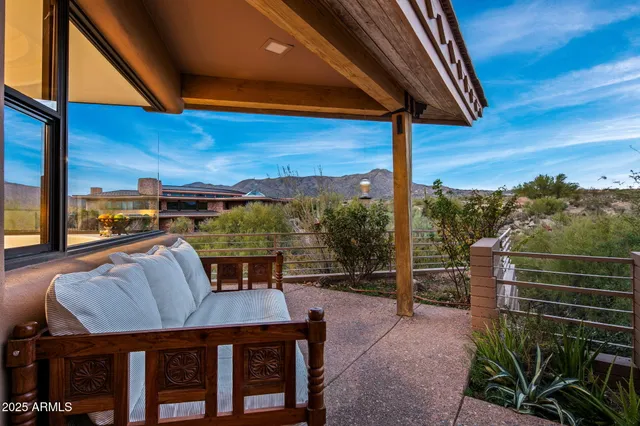 a dining room with furniture and a floor to ceiling window