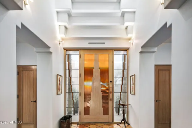 a living room with furniture and a floor to ceiling window