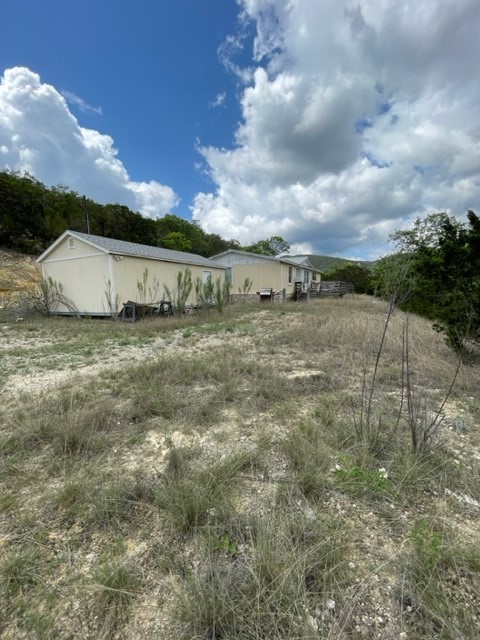 2250 Walter White Road Leakey, TX 78873 - Photo 15 of 21 a view of a dry yard with wooden fence