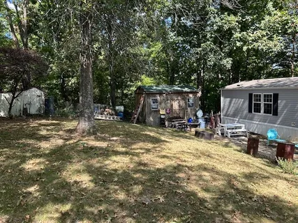 a view of a house with backyard porch and sitting area