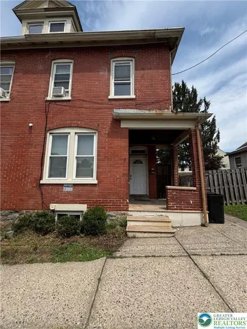a view of brick building with large windows