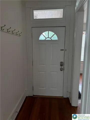 a view of an entryway with wooden floor