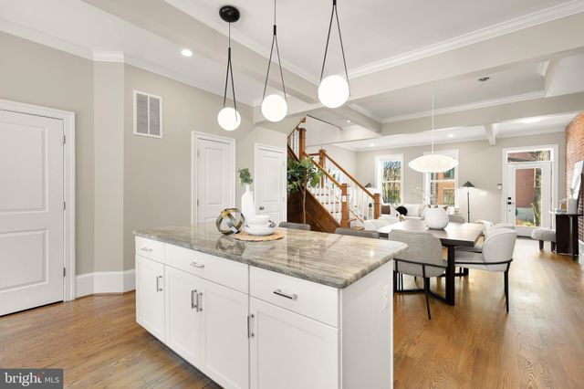 a view of a dining room and hall with wooden floor