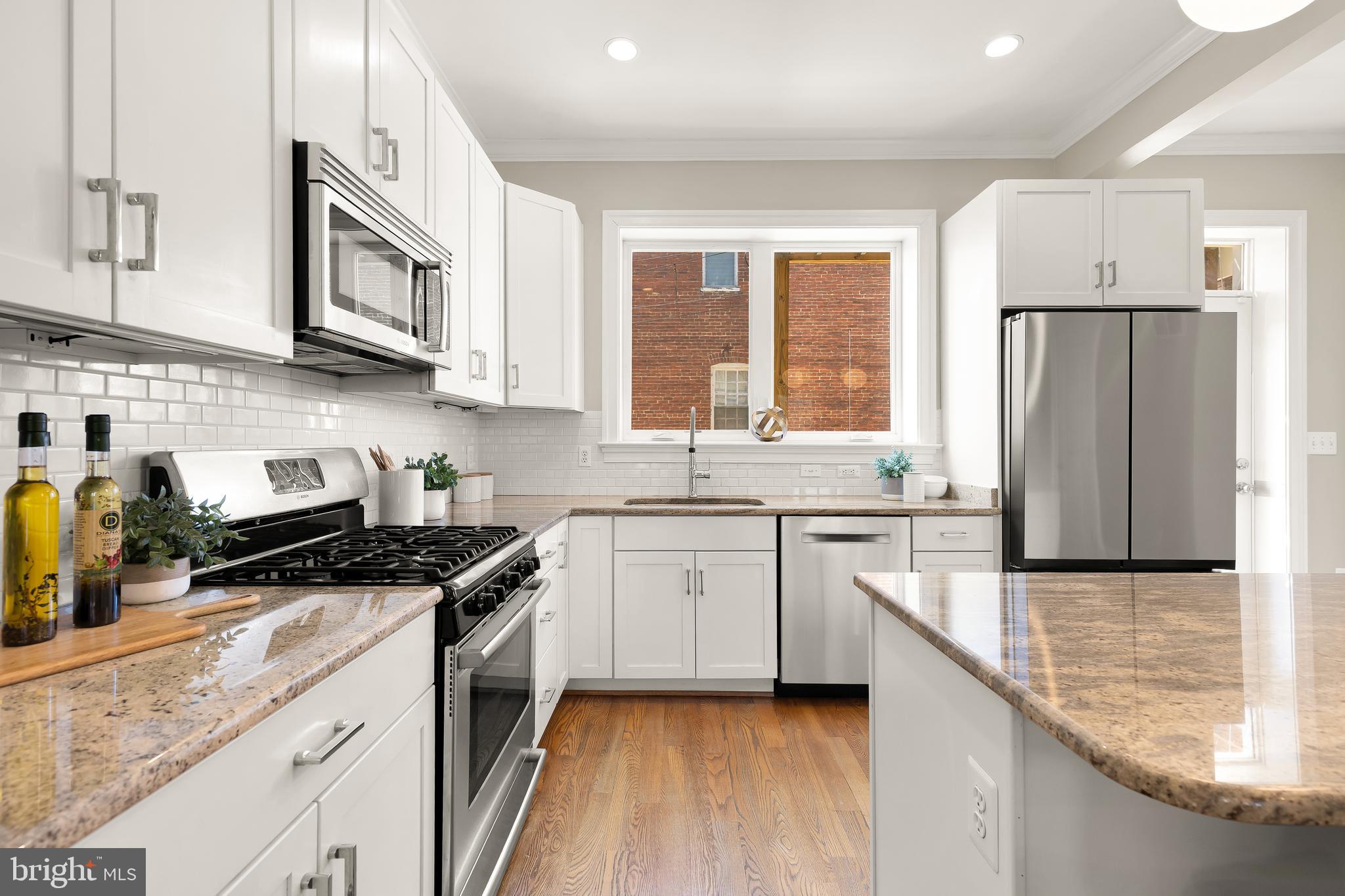 1722 2nd Street Northwest Washington, DC 20001 - Photo 12 of 33 a kitchen with granite countertop a refrigerator stove top oven and sink