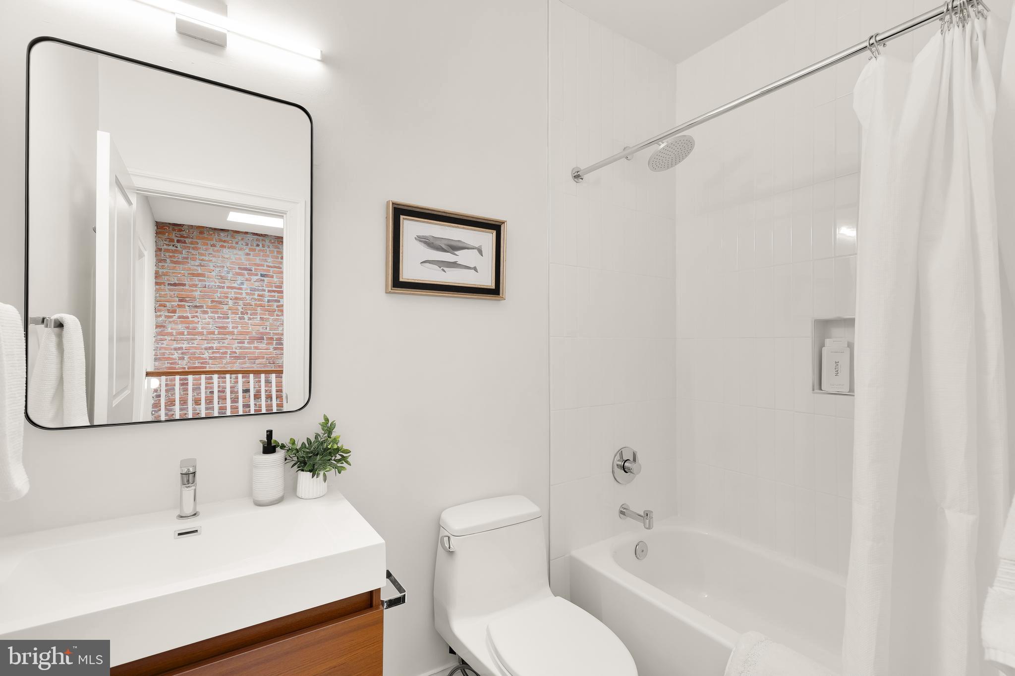 1722 2nd Street Northwest Washington, DC 20001 - Photo 20 of 33 a bathroom with a toilet a sink and a bathtub
