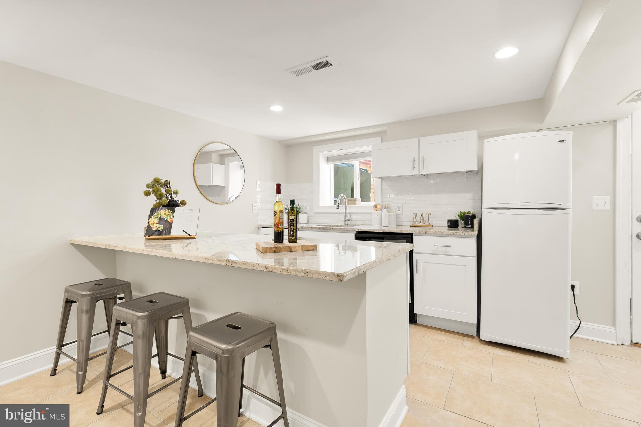 1722 2nd Street Northwest Washington, DC 20001 - Photo 26 of 33 a kitchen with white cabinets and white appliances