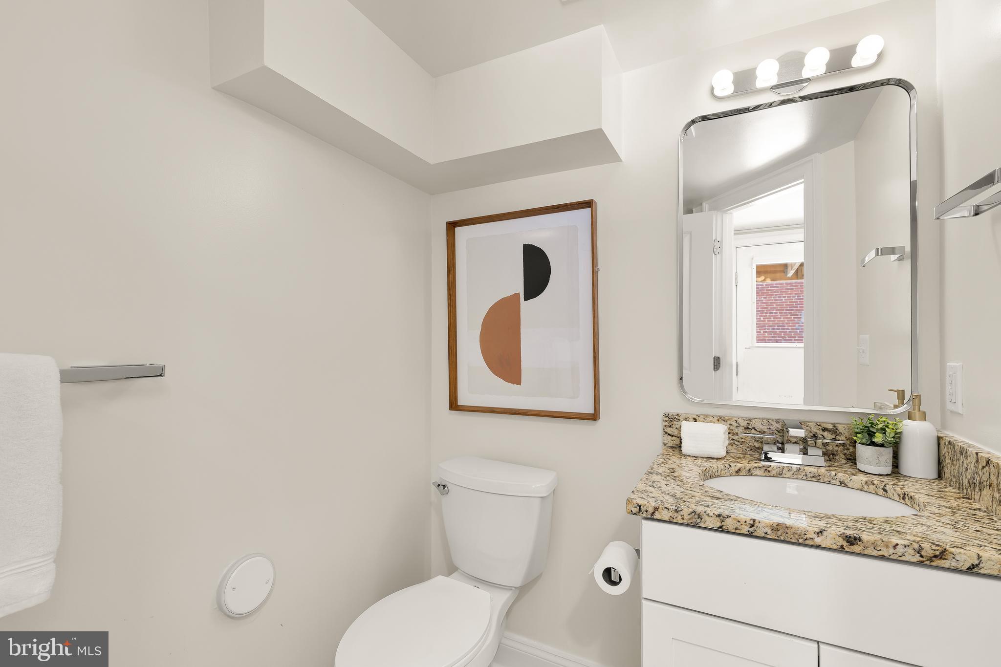 1722 2nd Street Northwest Washington, DC 20001 - Photo 29 of 33 a bathroom with a granite countertop toilet sink and mirror