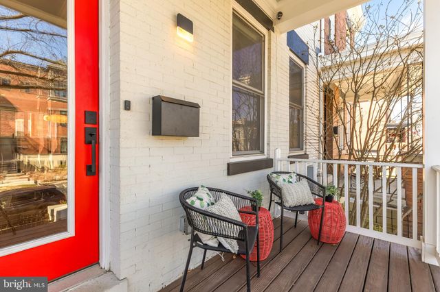 a view of a balcony with furniture and wooden floor