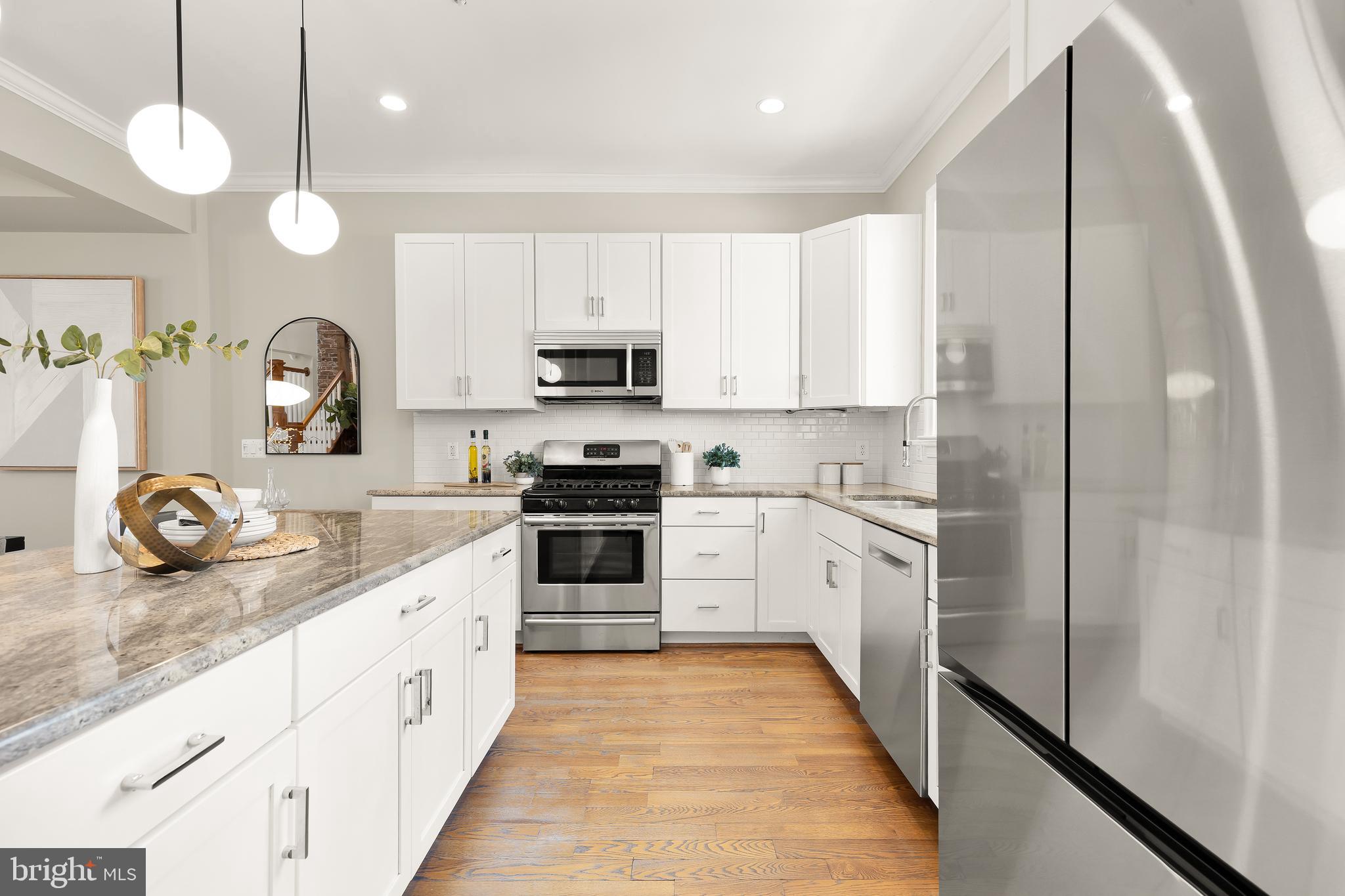 1722 2nd Street Northwest Washington, DC 20001 - Photo 10 of 33 a kitchen with stainless steel appliances granite countertop a refrigerator a stove top oven a sink and dishwasher