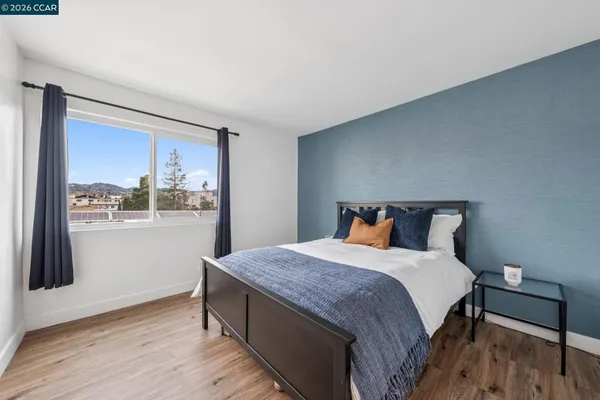 a bed sitting in a bedroom next to a window