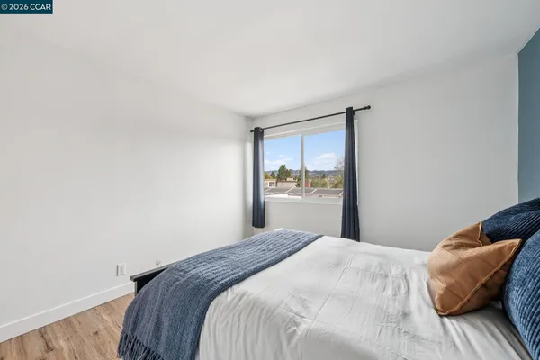 a bedroom with a bed and window