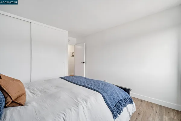 a bedroom with a bed and a chair