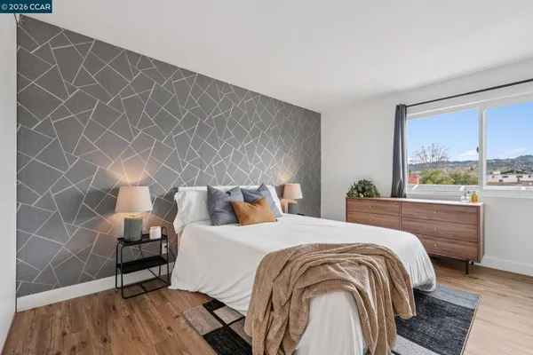 a bedroom with a bed and a window