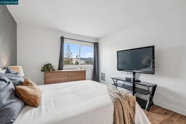 a bedroom with a bed and a flat screen tv