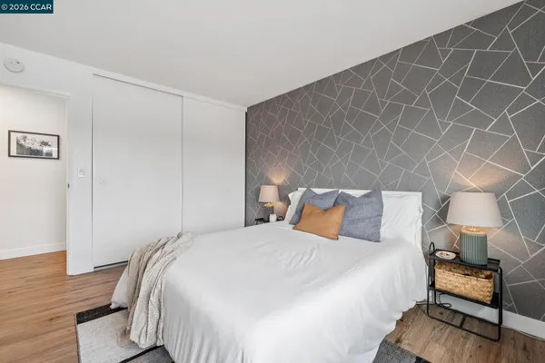 a bedroom with a bed and wooden floor