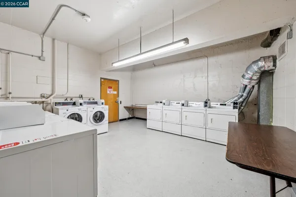 a view of a kitchen with sink washer and dryer