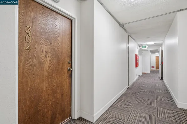 a view of hallway with wooden floor