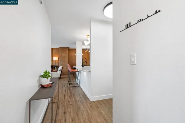 a view of a hallway view with wooden floor and a potted plant